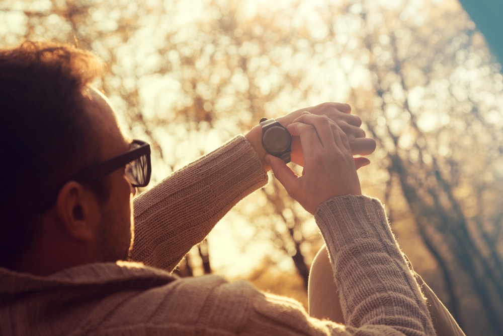 A man checking his watch. 