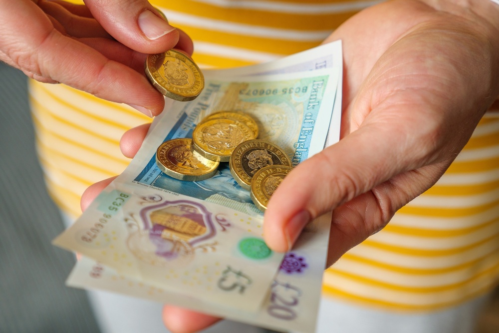A woman holding cash in her hands. 