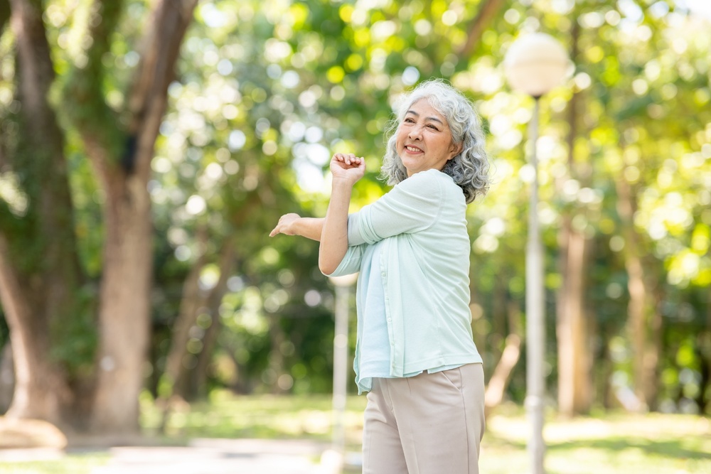 A woman stretching in a park.